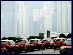 Views and typical red Hong Kong taxis at the entrance to ICC.