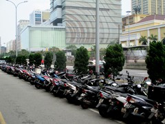 The Macau residents popular scooters stand in contrast to the casino visitors luxury cars.