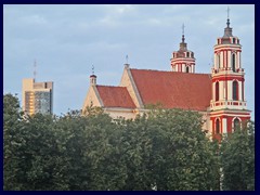 St Philip and St Jacob's Church, just North of Lukiškės Square. The church has recently been repainted from yellow to red. To the left in the background is Europa Tower, Vilnius tallest skyscraper.