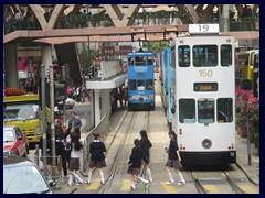 Hong Kong's school girls have uniforms, and so have the boys. Hennessy Road from the tram. Causeway Bay, Wan Chai district.