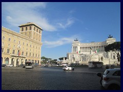 Piazza Venezia is heavily trafficated square in front of the national monument (to to Victor Emmanuel II). Piazza Venezia, is one of the most central places in Rome, as it's the end of Via del Corso and Via dei Foro Imperiali that leads to Colosseum. 
Here you also find Palazzo Venezia, that gave the square it's name. This renaissance palace was built 1455-64 as a papal residence, but houses today the Museo del Palazzo Venezia, a musuem of paitnings and arts. It has also been used as Mussolini's headquarters and as Venice's embassy.
Opposite is Palazzo Generali, that is almost a copy of Palazzo Venezia. Palazzo Bonaparte is another palace, it was named after Emperor Napoleon I:s mother, who lived inside as the pope granted her asylum there after the empire fell.
