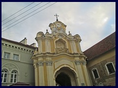 Holy Trinity Church & Basilian Gate, Didzioji street. A famous symbol can be found on top of this baroque gate that is part of the church.